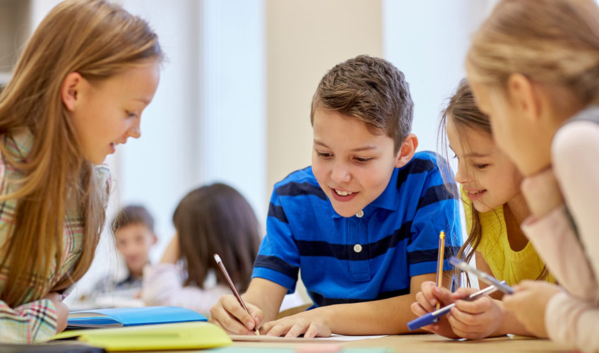 Schülerinnen und Schüler beim Schreiben und Sprechen